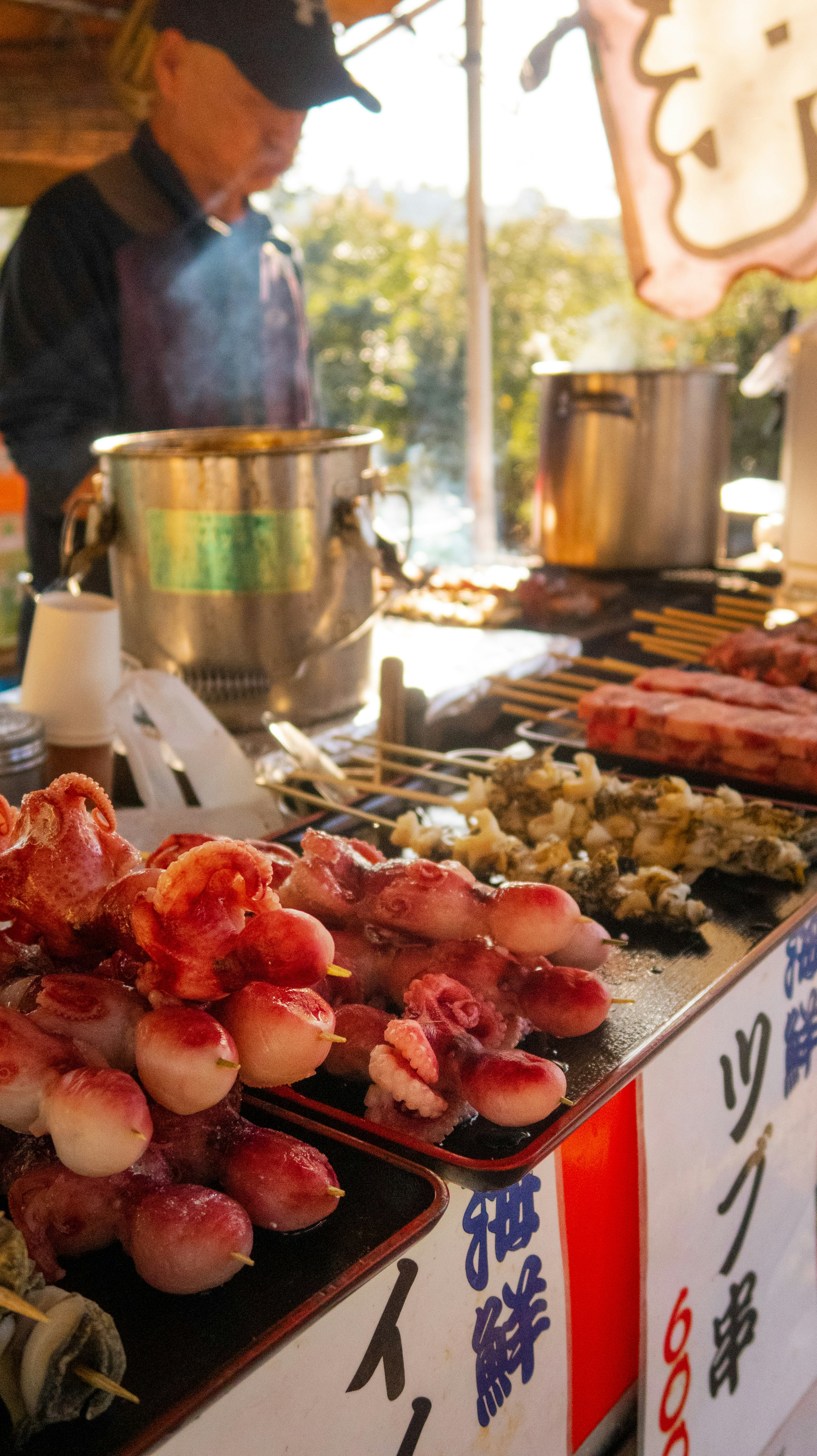 Steaming bowls of fresh ramen and seafood at a bustling Hokkaido street market